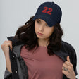 Girl wearing navy number 22 dad hat