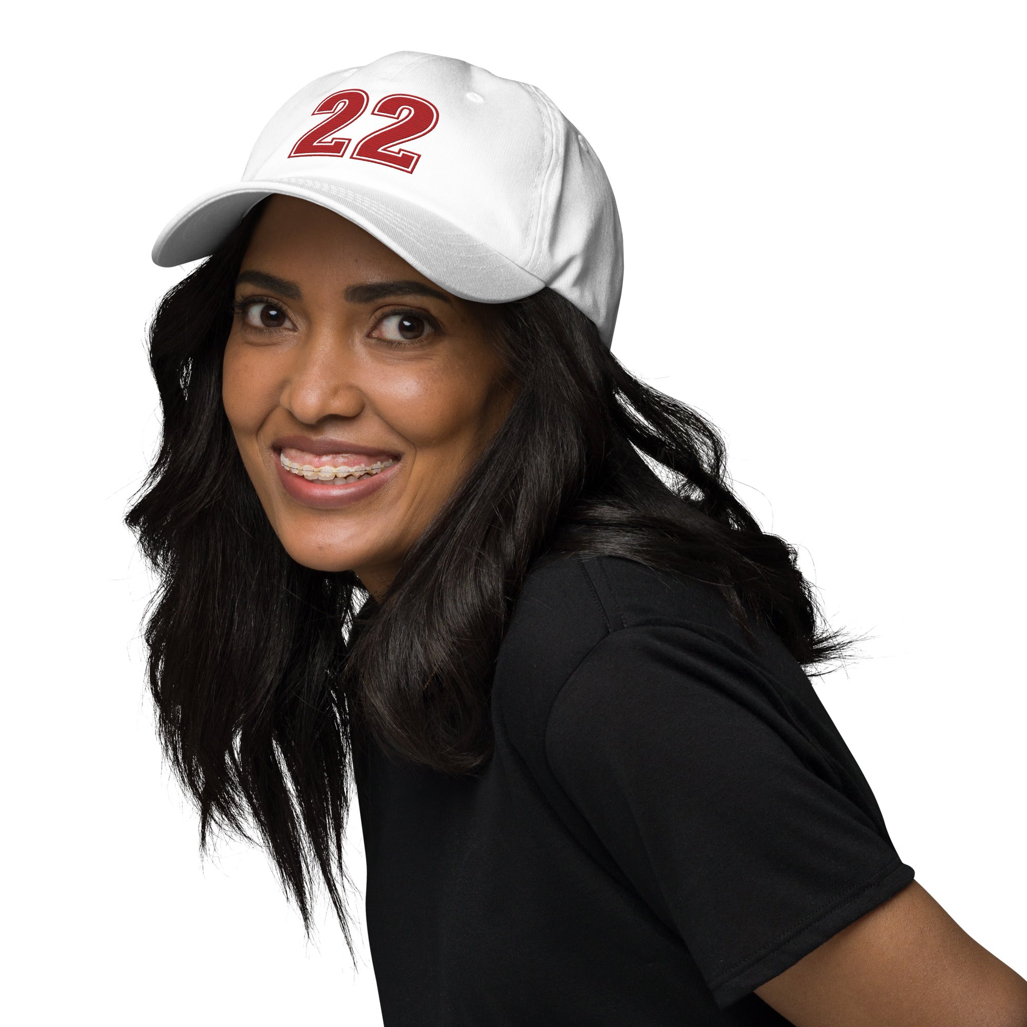 Girl wearing white number 22 dad hat